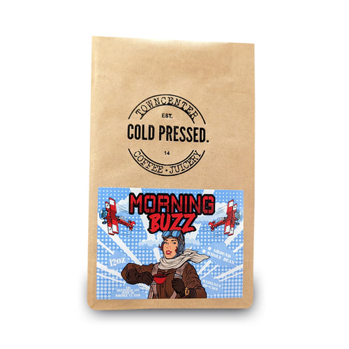 Shown here is a 12-ounce coffee bag of our High Caffeine Morning Buzz Hazelnut Flavored Coffee sold by Town Center Cold Pressed and proudly roasted in Norfolk, VA.